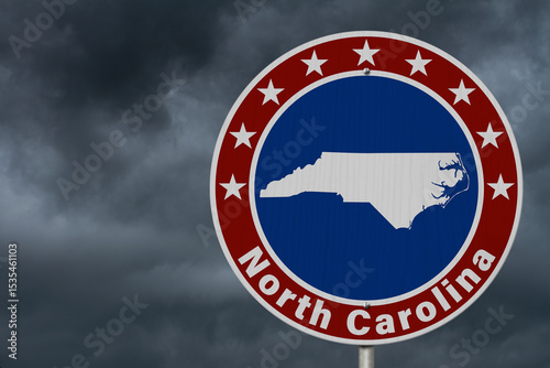 North Carolina map with stars on a US red, white and blue road sign
