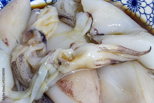 Pile of squids in bowl ready for grilling, close up