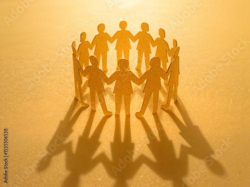 Symbolic Representation of Unity and Collaboration, A Circle of Paper People Holding Hands in Warm Golden Light