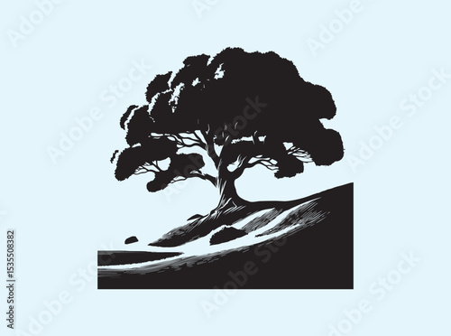Majestic oak tree on a hilltop with blue sky in background