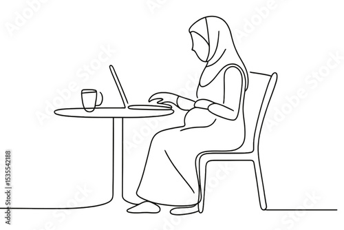 Woman in hijab working on laptop at table with cup during daytime