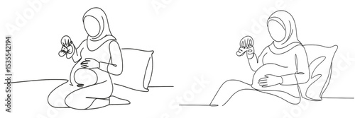 Two pregnant women joyfully engaging with baby toys while seated comfortably in a cozy indoor space