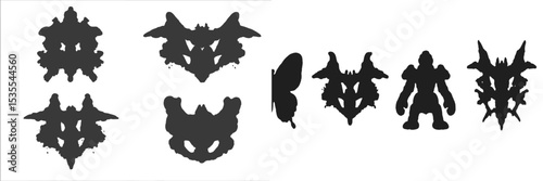 Artistic display of abstract ink blots created with black ink showcasing various shapes and figures
