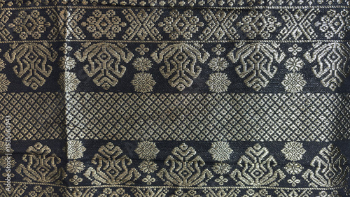 Black songket, traditional Malay woven textile with beautiful pattern made from golden sewing