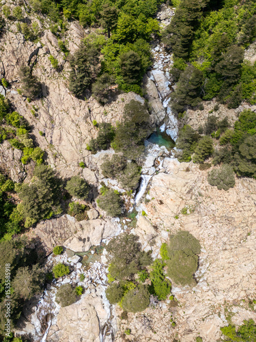 Aerial view of the Cascade des Anglais on the L'Agnone river flowing through the forest and mountains along the GR20 trail at Vizzavona on the Mediterranean island of Corsica
