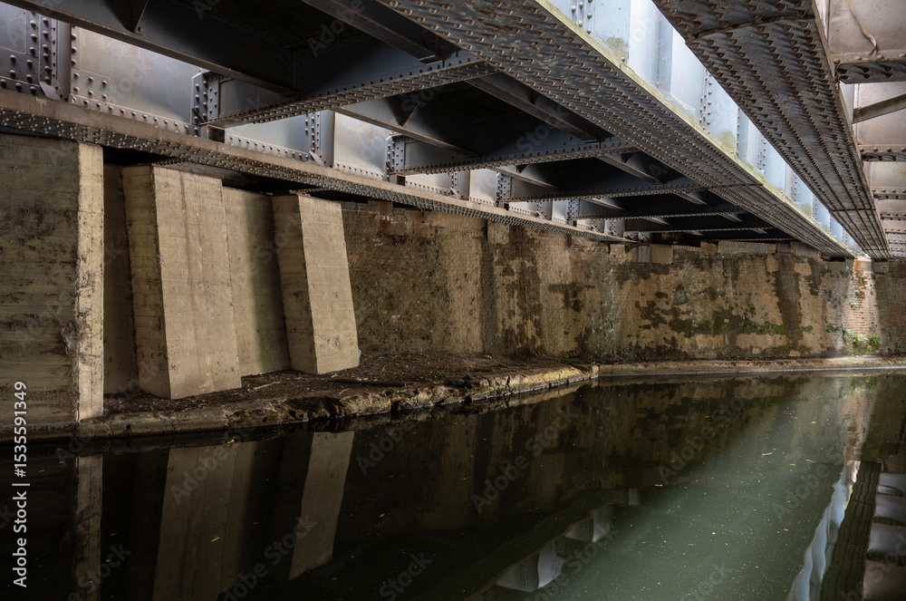 Obraz premium Underside of the railway bridge where the Great Western Main Line crosses the Grand Union Canal in Hayes, West London, UK.
