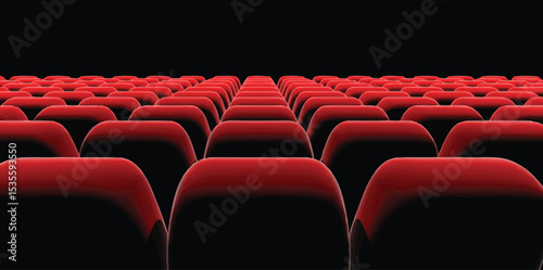Empty Theater Seats: Rows of plush red seats in a darkened movie theater, await the eager audience in anticipation of the film to start.