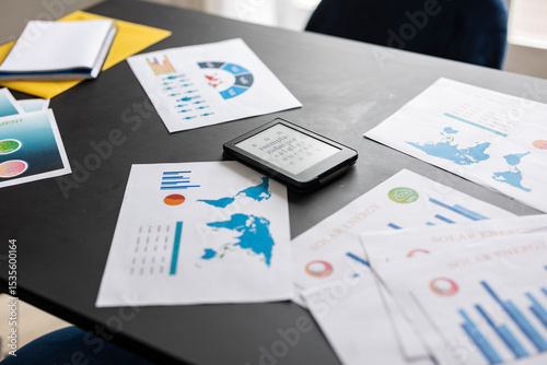 Tableau sur toile E reader laying on desk showing nonsense text surrounded by business charts and