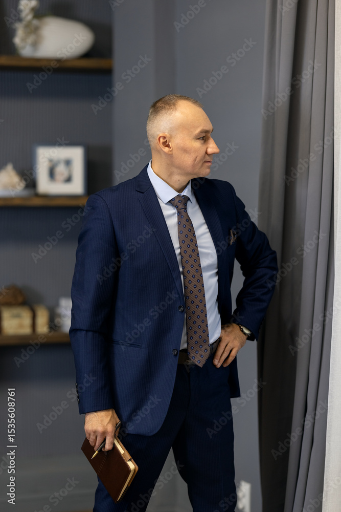 Portrait of handsome successful confident man. Elegant mature businessman. Adult employee business man corporate lawyer, he wear classic formal suit shirt tie work in office with book Portrait of handsome successful confident man. Elegant mature businessman. Adult employee business man corporate lawyer, he wear classic formal suit shirt tie work in office with book