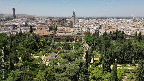 Aerial view from a drone of beautiful old Royal Alcázar of Seville with garden in Seville, Spain in sunny summer weather
