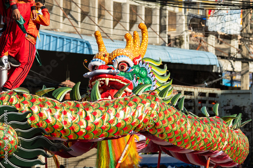 Chinese dragon dance show on street in the Chinese New Year festival.Chinese dragon costume used during Chinese New Year celebration in China town.Holidays and celebrations concept. Selective focus.