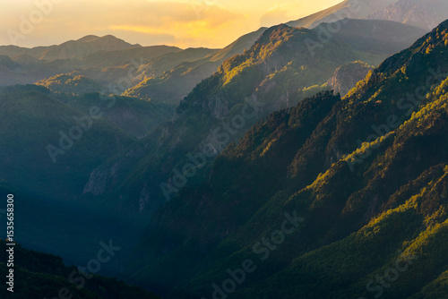 Sutjeska National Park in Bosnia and Herzegovina. Sunset in the mountains of Bosnia in the area of Prijevor and Veliki Maglic. Illuminated mountain massif on the border with Montenegro