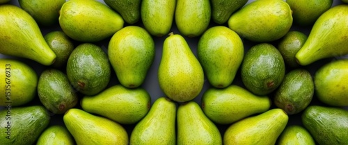 A vibrant symmetrical arrangement of fresh, green avocados, exhibiting their smooth skin and slight pear shapes,  diet,  background