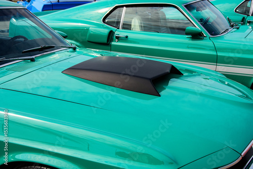 Hood scoop on a performance vehicle on display at car show.