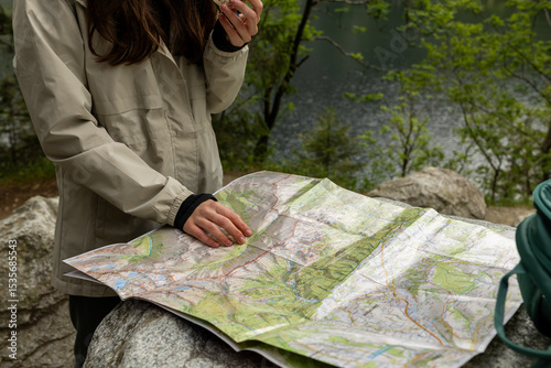 Cuadro en lienzo Young woman studying a map of Tatra National Park, planning hiking routes in the