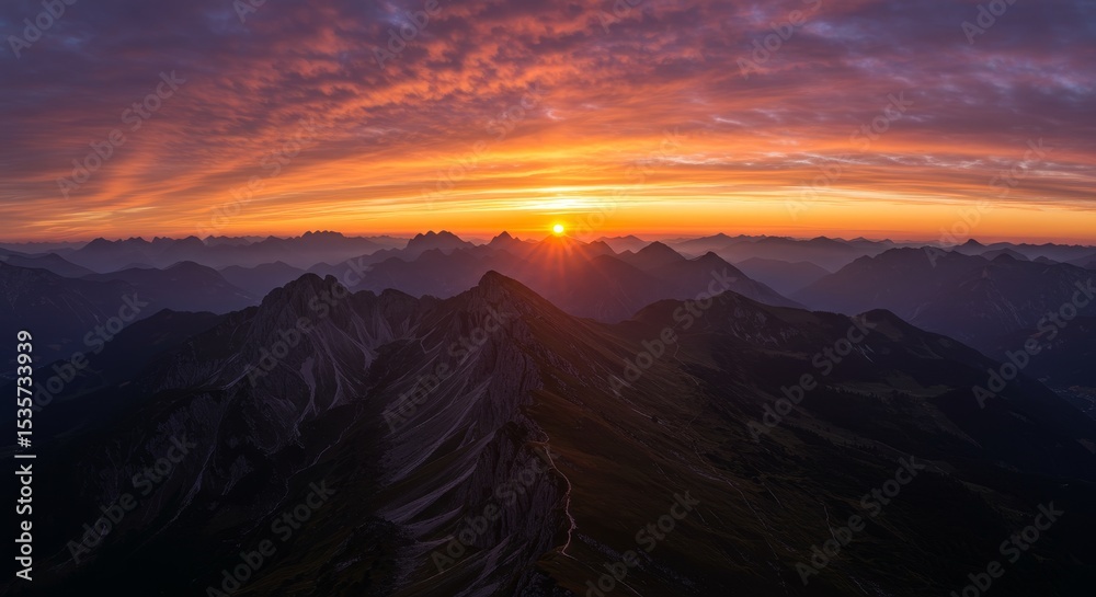 Fototapeta premium Majestic Mountain Sunset Panorama - Serene sunset over majestic mountains, symbolizing peace, adventure, nature's beauty, tranquility, and hope. A breathtaking view of fiery colors at dawn