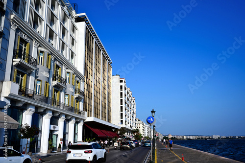 Fototapeta Naklejka Na Ścianę i Meble -  Thessaloniki waterfront, seashore in the old port. famous and popular concrete walk or seafront promenade in perspective view. beautiful white hotel buildings and blue sea. travel and tourism concept.