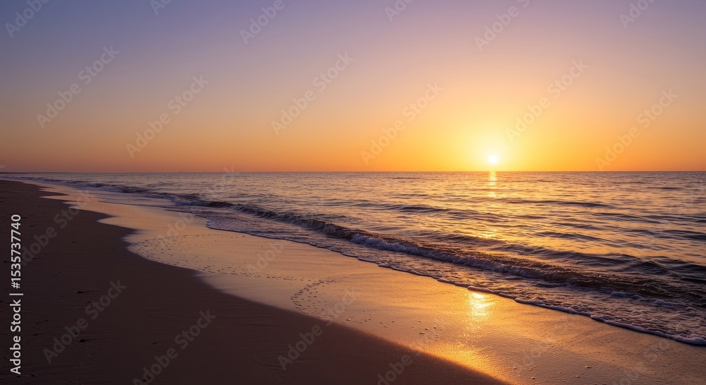 Obraz premium Serene Sunrise Beachscape - Tranquil sunrise over a calm ocean, golden light reflecting on the wet sand. Peaceful beach scene at dawn