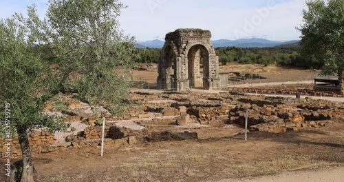 Roman ruins of Caparra with its arch and olive groves.