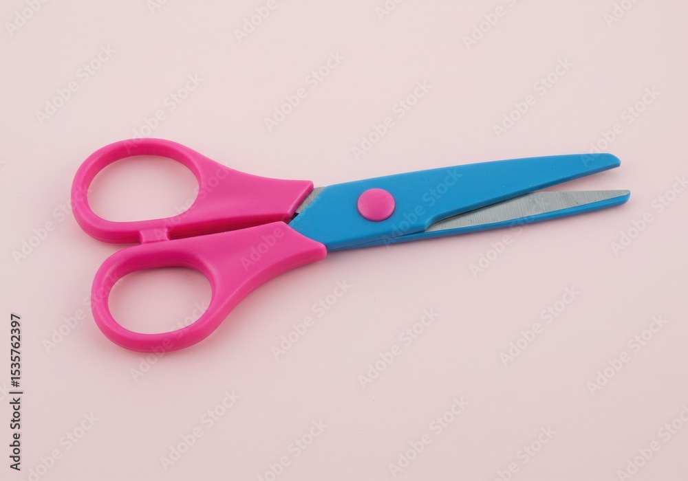 Pink and blue scissors on pink background Pink and blue scissors on pink background