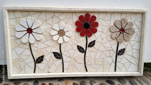 framed mosaic wall art featuring stylized flowers in mixed stone tiles and bold red accents on neutral background