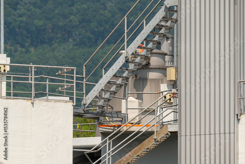Biogas production facility closeup. Stairways for maintenance workers to get to the top of the equipment.