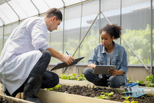 Practical agricultural studies of adolescent students, with scientists providing guidance, demonstrating hypotheses on soil sampling and data recording in greenhouse. Hands-on training in high school
