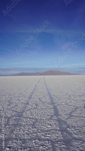 Cinematic photos over the Uyuni Salt Flats in Bolivia, endless white landscapes under a vast blue sky
