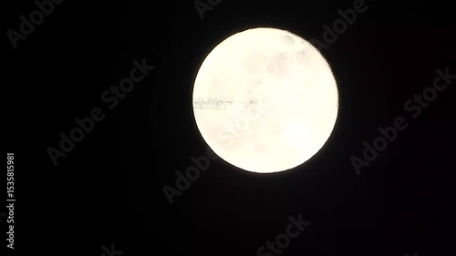 full moon in the night - a plane passes in front of the  full moon photo