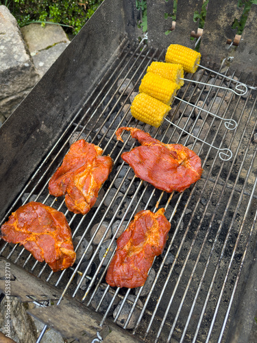 Pork Steaks and Corn on a Grill with Charcoal