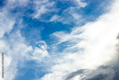 Fototapeta Naklejka Na Ścianę i Meble -  Wispy clouds drifting across a vivid blue sky