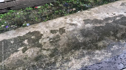 rain on the street,Raindrops on the concrete floor,Raindrops that hit the water surface.Raindrops splashing on a cement concrete floor