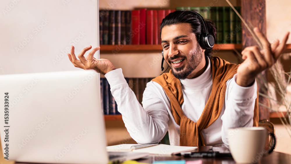 Fototapeta premium Happy Arab Man Teacher Having Virtual Lesson Via Video Call Sitting At Laptop Explaining Lecture Remotely Working From Home. E-Teaching And Distance Tutoring, Modern Online Education