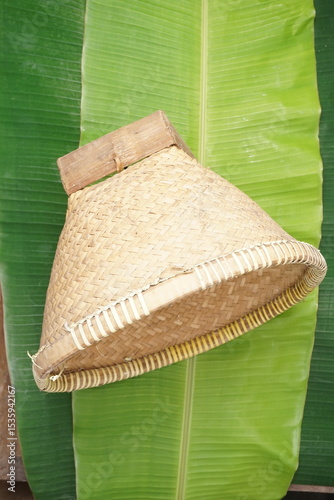 bamboo basket for rice container, banana leaf background