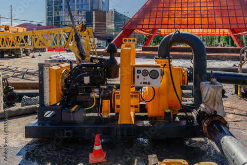 Cleaning sewer manholes by specialized pump machine on the street