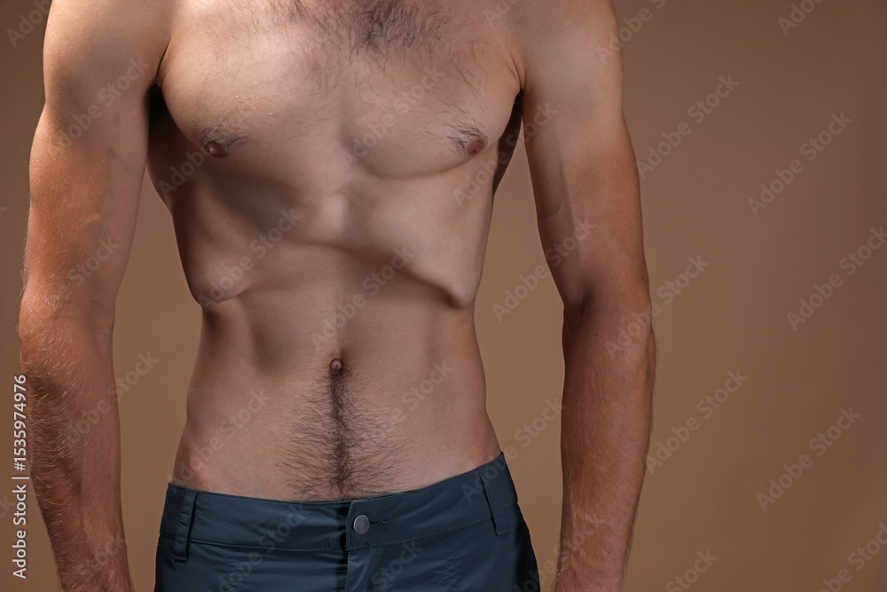 Fototapeta premium Man suffering from anorexia on beige background, closeup