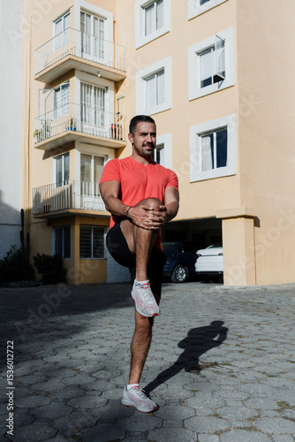 young healthy Latin man stretching or doing warm up exercise preparing workout at home in Mexico Latin America. fitness hispanic male outdoors 