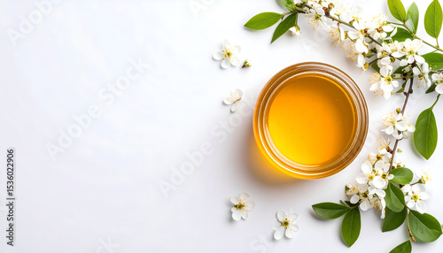 Overhead Shot of Honey Jar with White Cherry Blossoms on White Background