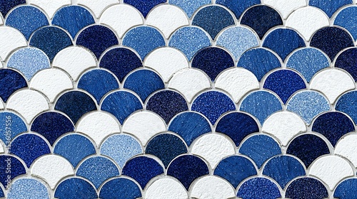 A fishscale pattern of blue and white ceramic tiles.