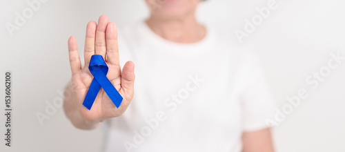 Photos Elderly with dark Blue or Navy blue Ribbon for concept of March Colorectal and Colon Cancer Awareness month, May Arthritis awareness, July Juvenile arthritis and Childhood