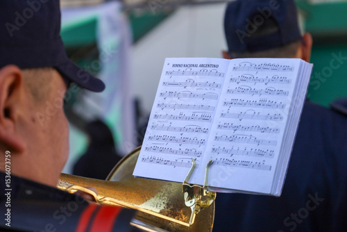 Score of the Argentine national anthem supported by a trumpet photo