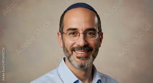 Portrait of a Smiling Man Wearing a Kippah and Glasses