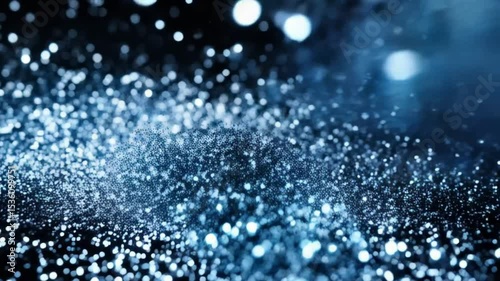 A sparkling blue dust cloud with bokeh lights on a dark background creating a magical atmosphere