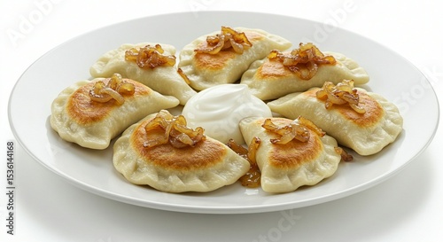Golden Fried Dumplings Topped with Caramelized Onions and Cream Sauce on White Plate