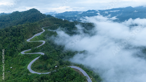 Aerial view of the folding cloth bend, Nan Province, a beautiful road that curves along the mountain, full of trees, fog and clouds, a tourist attraction in Nan.