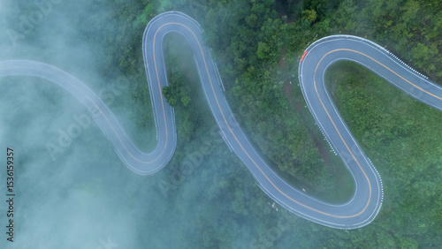 Aerial view of the folding cloth bend, Nan Province, a beautiful road that curves along the mountain, full of trees, fog and clouds, a tourist attraction in Nan.