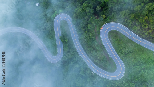 Aerial view of the folding cloth bend, Nan Province, a beautiful road that curves along the mountain, full of trees, fog and clouds, a tourist attraction in Nan.