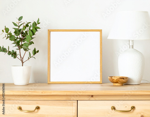 Empty Picture Frame: A clean and minimalist interior with a blank square frame, offering ample space for your own creative vision. A natural wooden table, complete with a touch of greenery.