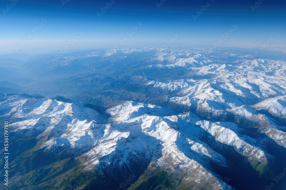 Fototapeta premium Aerial photo of mountain ranges with snow-capped peaks, earth science and geography