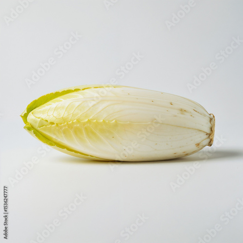 Belgian endive sits awaiting preparation its pale leaves promising a crisp refreshing addition